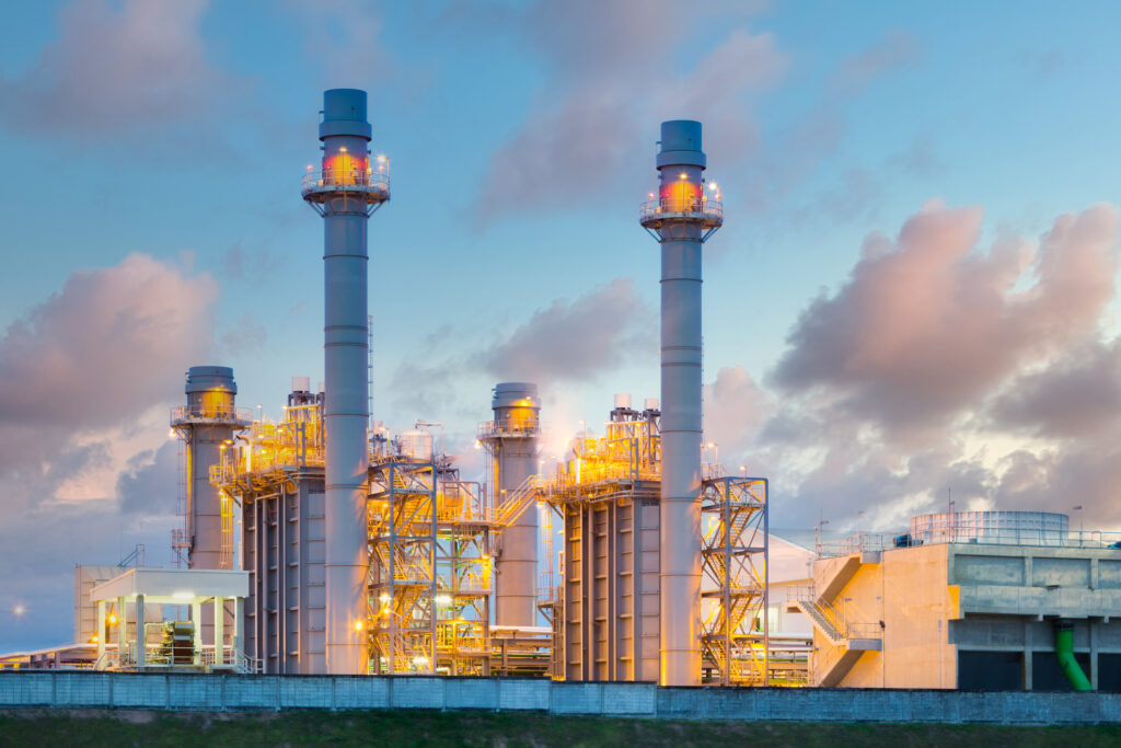 Gas fired power plant and factory building at night. Also called gas fired power station or natural gas power plant. That technology to burn natural gas and generate electricity or electrical energy.