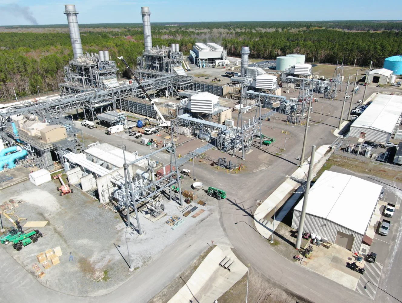 Aerial view of industrial vent silencers being used to reduce noise from high-pressure steam or gas releases in a power plant.