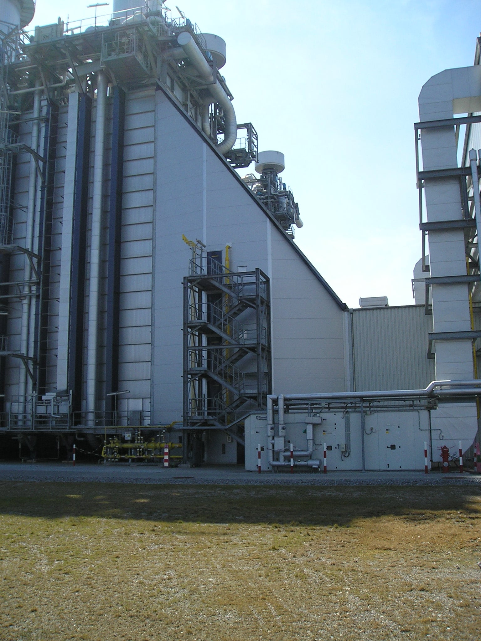 Acoustical shroud on industrial building and equipment to meet environmental noise reduction requirements.